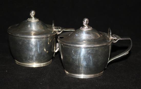 A pair of Victorian silver oval mustard pots with blue glass liners, Frederick Brasted, London, 1876.